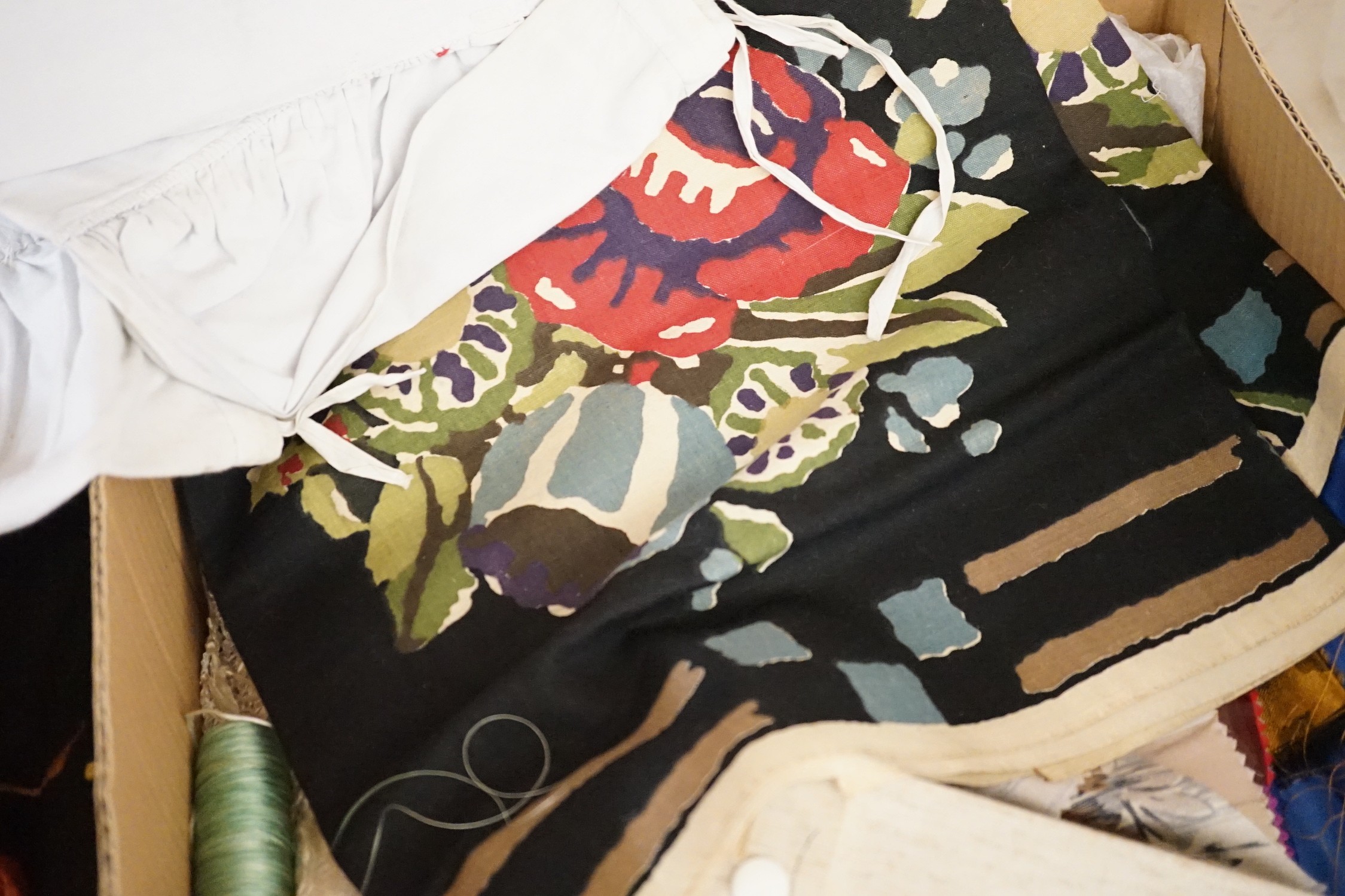 A large collection of mixed European textiles including ribbon worked pyjama cases, Indian painted textiles, a sample book of braidings etc
